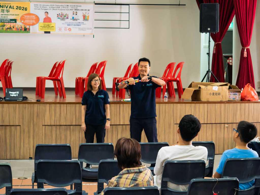 Two persons demonstrating using a folding cane